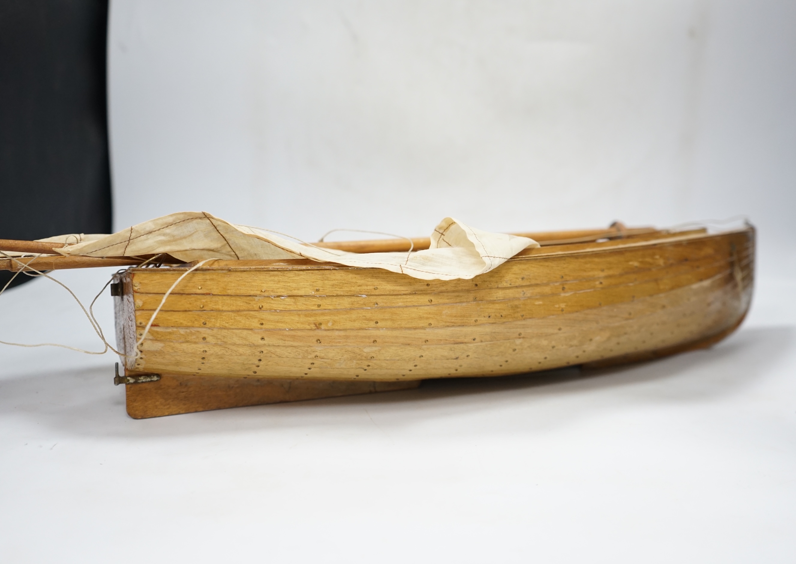 A mid 20th century kit built wooden model sailing boat, ‘Rob’, of plank on frame construction with white painted interior, hull 45cm long. Condition - fair to good.